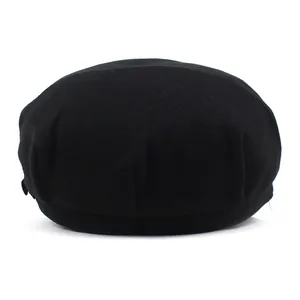 Classic black wool baker boy newsboy cap with textured panels on white background