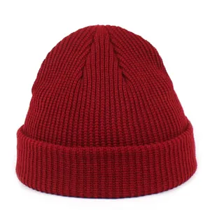 Close-up of wine red ribbed knit beanie showing textured acrylic yarn and thick cuff
