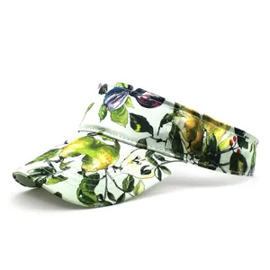 Detail of printed visor cap with realistic pear and plum motifs on white background