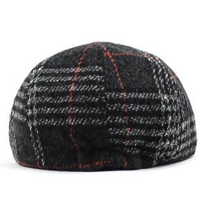 Detailed view of the thick wool plaid fabric and dense texture on this vintage beret hat