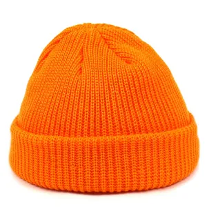 Close-up of bright orange ribbed knit beanie showing thick acrylic texture and stitching