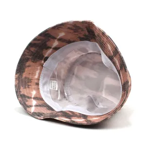 Brown and beige tie-dye cotton bucket hat with interior view showing 100% cotton lining