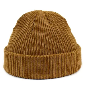 Detail of caramel brown ribbed knit beanie showing textured acrylic yarn and cuff design