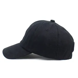 Side view of plain black cotton twill baseball cap with six-panel structure and curved brim