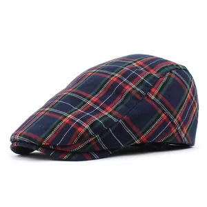 Detailed view of the dark blue plaid check pattern on this classic flat cap for adults
