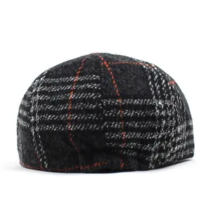 Close-up of the vintage plaid wool flat cap showing fabric texture and sewing details