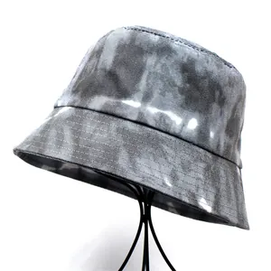 Detail view of metallic grey bucket hat texture with multi-row stitched brim on stand