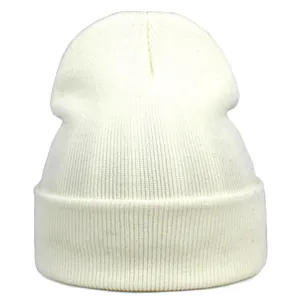 Detailed knit texture of an ivory white acrylic beanie with a classic folded cuff design