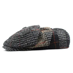 Three vintage plaid newsboy caps in gray and brown wool blend on white background