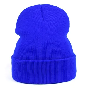 Detailed view of bright blue ribbed knit beanie featuring wide cuff and soft texture