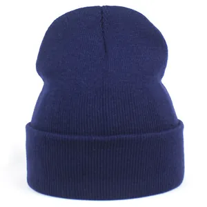 Close-up of navy blue acrylic knit beanie with ribbed texture and folded edge