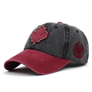 Close-up of vintage washed cotton baseball cap with maple leaf patch and side embroidery