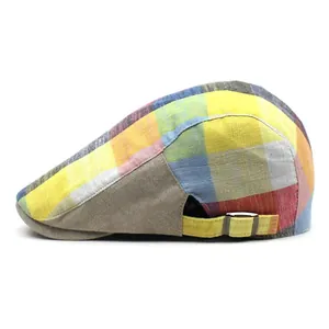 Close-up of a plaid beret with adjustable metal side buckle and cotton-linen texture