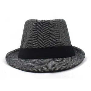 Close-up of stylish herringbone fabric texture and black ribbon on a men's jazz fedora hat