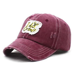 Detailed view of the distressed burgundy cotton baseball cap with I do Crew embroidery