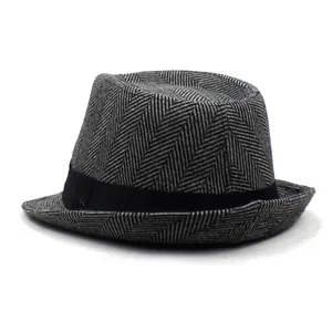 Close-up of the grey herringbone fabric texture and black ribbon on a men's jazz hat