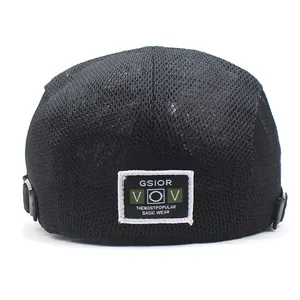 Detail view of breathable mesh texture and adjustable metal buckle on a black cap