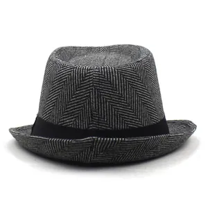 Close-up of grey and black herringbone texture on the wide-brimmed felt fedora hat