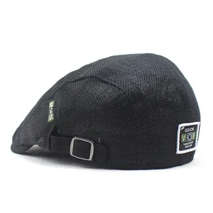 Detail of breathable black mesh flat cap featuring sports tag and adjustable metal buckle