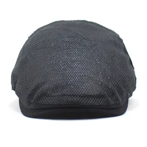 Detailed close-up of breathable black mesh fabric on a stylish men's summer ivy cap