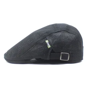 Close-up of black mesh cap with green SPORTS label and adjustable metal buckle strap