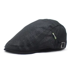 Detail view of black mesh ivy cap with green SPORTS label and metal buckle closure