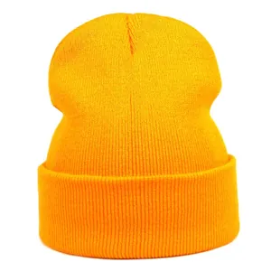 Detail of ginger orange knit beanie showing fine vertical ribbing and wide folded cuff
