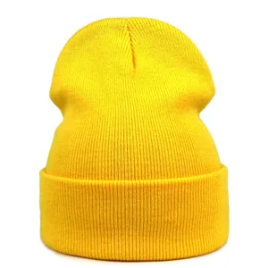 Detailed view of bright yellow rib-knit beanie showing soft texture and folded cuff