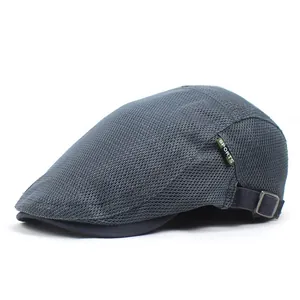 Detail of dark grey mesh beret with green SPORTS tag and adjustable metal buckle