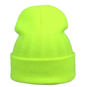 Detail view of the thick ribbed knit texture on a fluorescent yellow winter beanie hat