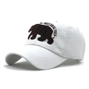 Detailed close-up of Yellowstone National Park bear embroidery on white cotton baseball cap