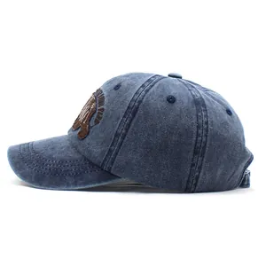 Detail of North Park bear patch embroidery on a blue washed cotton baseball cap