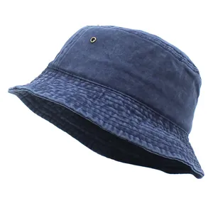 Close-up of navy blue washed cotton bucket hat showing metal eyelet and stitched brim