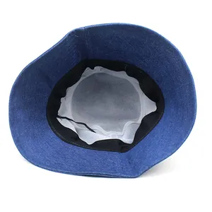 Internal view of blue denim bucket hat featuring white lining and black sweatband