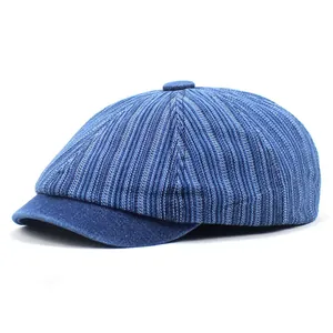 Detail of blue denim ivy cap featuring vertical stripe patterns and a vintage style brim