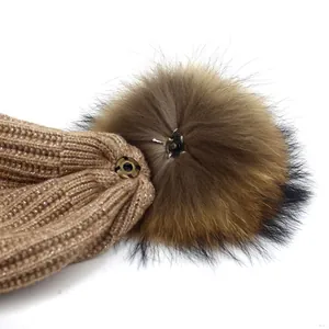 Winter knit beanie with sparkling silver thread and a detachable raccoon fur pom-pom