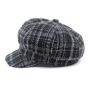 Detail of classic black and white plaid newsboy hat with textured tweed fabric