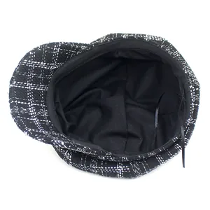 Classic black and white plaid newsboy cap with warm lining and adjustable interior ribbon