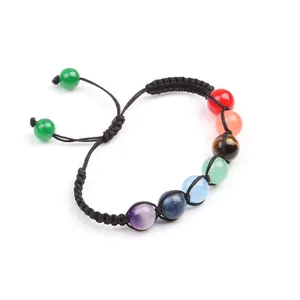 Detailed view of handmade chakra bracelet with seven natural stones and adjustable braided rope