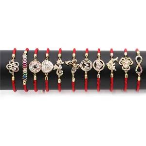 Red braided cord bracelets with gold-plated charms and colorful cubic zirconia