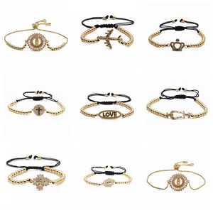 Dettagli di nove bracciali di perline regolabili con ciondoli oro croce e malocchio