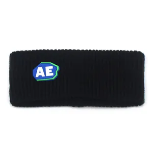 Macro shot of black knitted sports headband with a layered blue and green AE logo badge