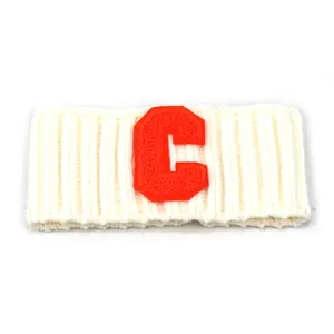Nahaufnahme von weißem Strickstirnband mit rotem Chenille-Buchstaben-C-Patch