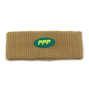 Winter knitted sport headband in camel with vertical ribs and green PPP logo patch