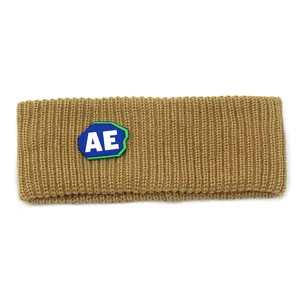 Detail of khaki knitted headband showing ribbed texture and a stitched AE letter badge