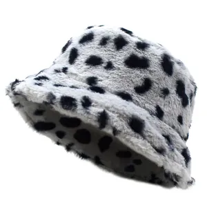 Detailed view of plush faux fur texture and cow pattern on a winter bucket hat