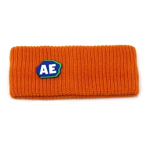 Vibrant orange knitted sports headband with AE letter patch and ribbed texture
