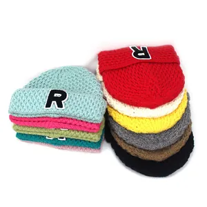 Stack of colorful knitted beanies with letter R embroidery for winter warmth and style