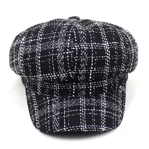 Classic black and white plaid newsboy cap featuring a tweed texture and vintage round crown