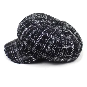 Detail of classic black and white houndstooth tweed texture on a retro newsboy cap